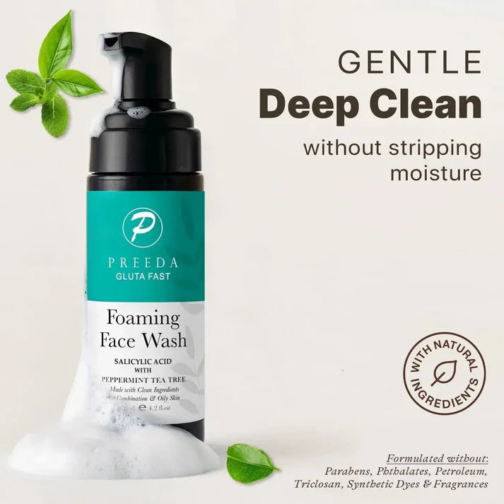Preeda foaming face wash bottle with green leaves on a light background